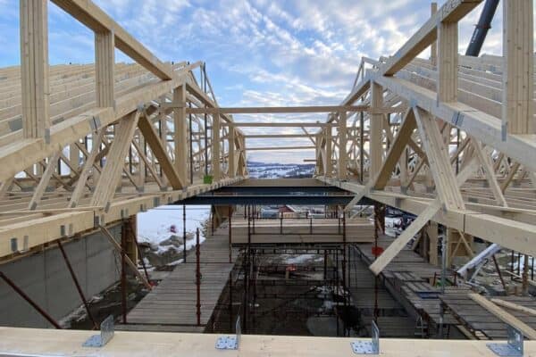 Trebygg under oppføring i landbruks- eller næringsbygg, fokus på landbruksbygg Innlandet, nybygg, konstruksjon av gjødselboder, fjøs, lagerbygg, skreddersydde bygninger, bærekraftige byggeløsninger, erfarne håndverkere, landbrukskonstruksjon, byggeservice i Innlandet-route.